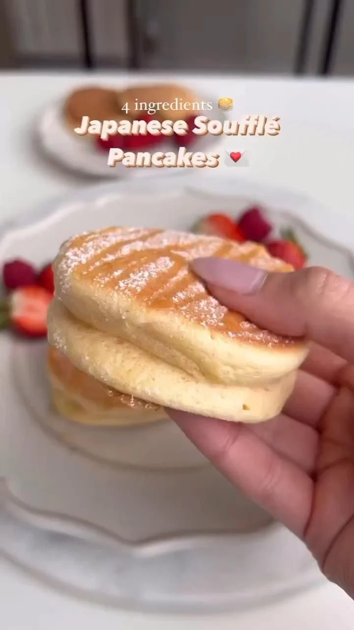 fluffy pancakes with strawberries and syrup